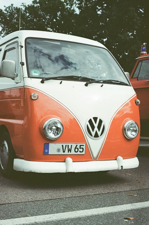 an orange and white bus parked on the side of the road