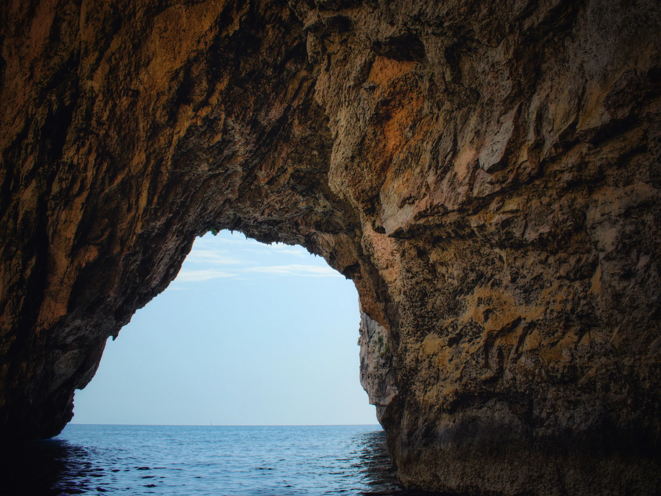 view of the ocean from inside a cave