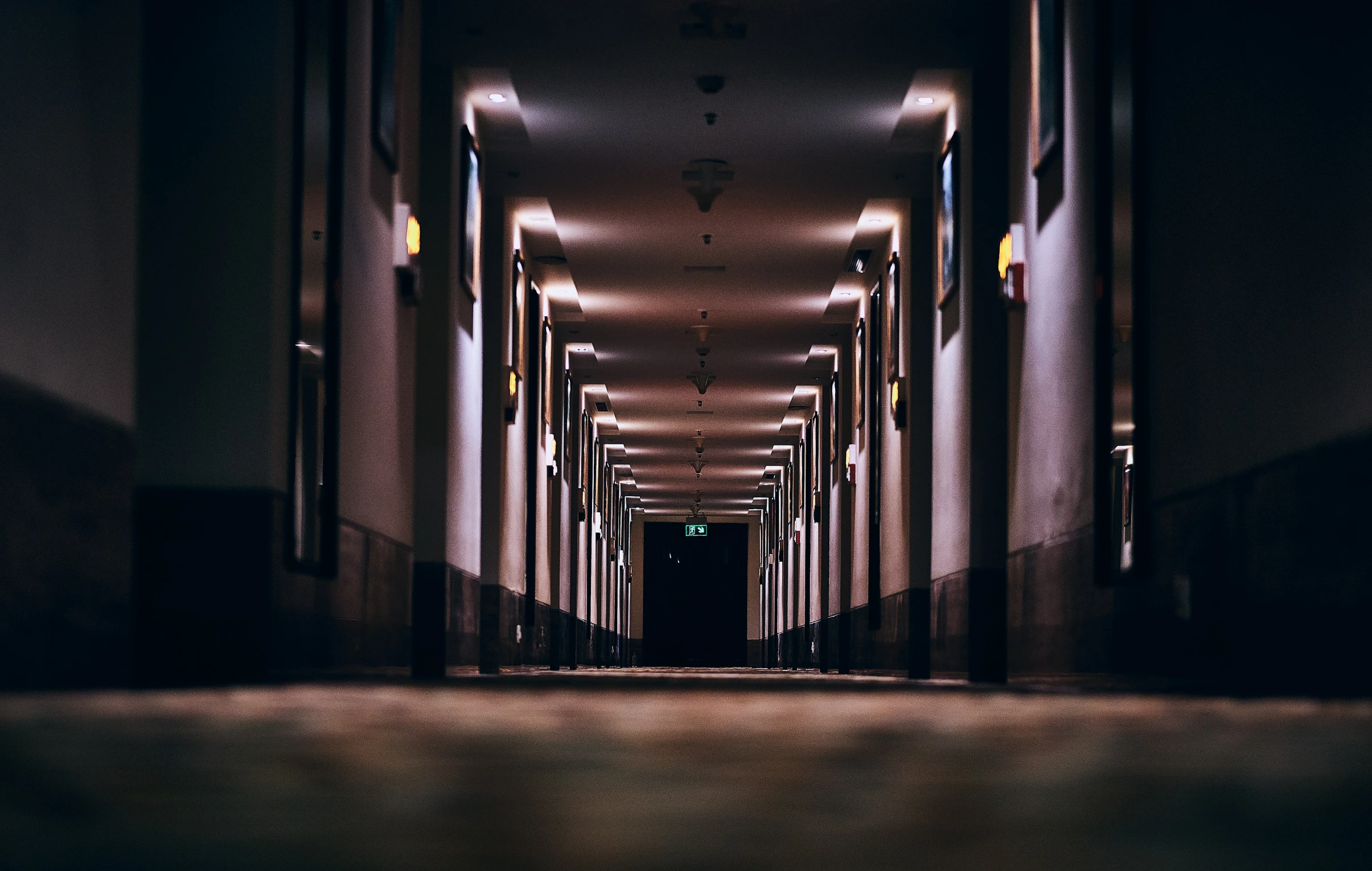 an empty corridor with a line of buildings