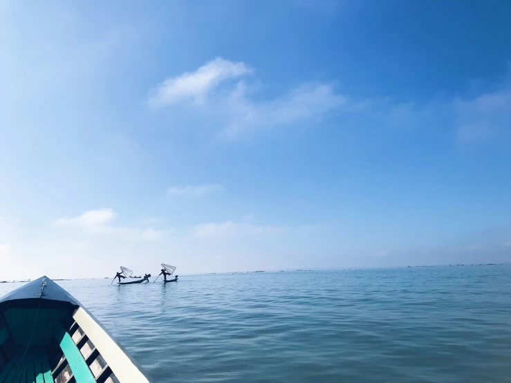 a long boat sits in the middle of the ocean