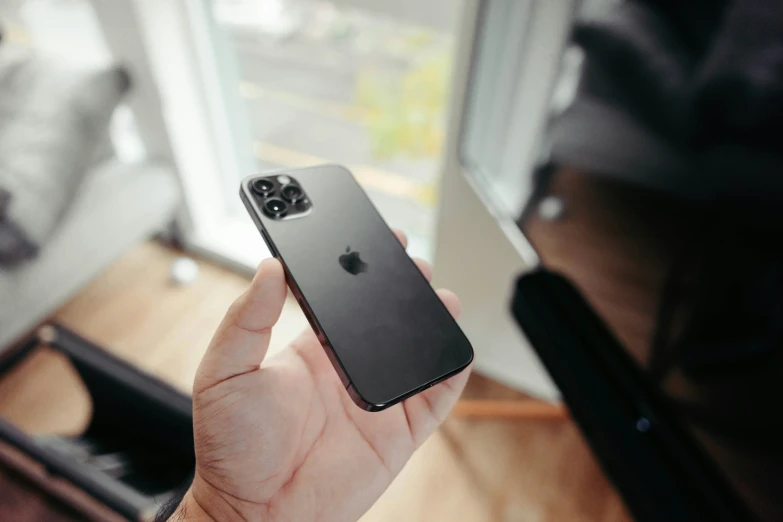 an iphone 11 is held up in front of the camera