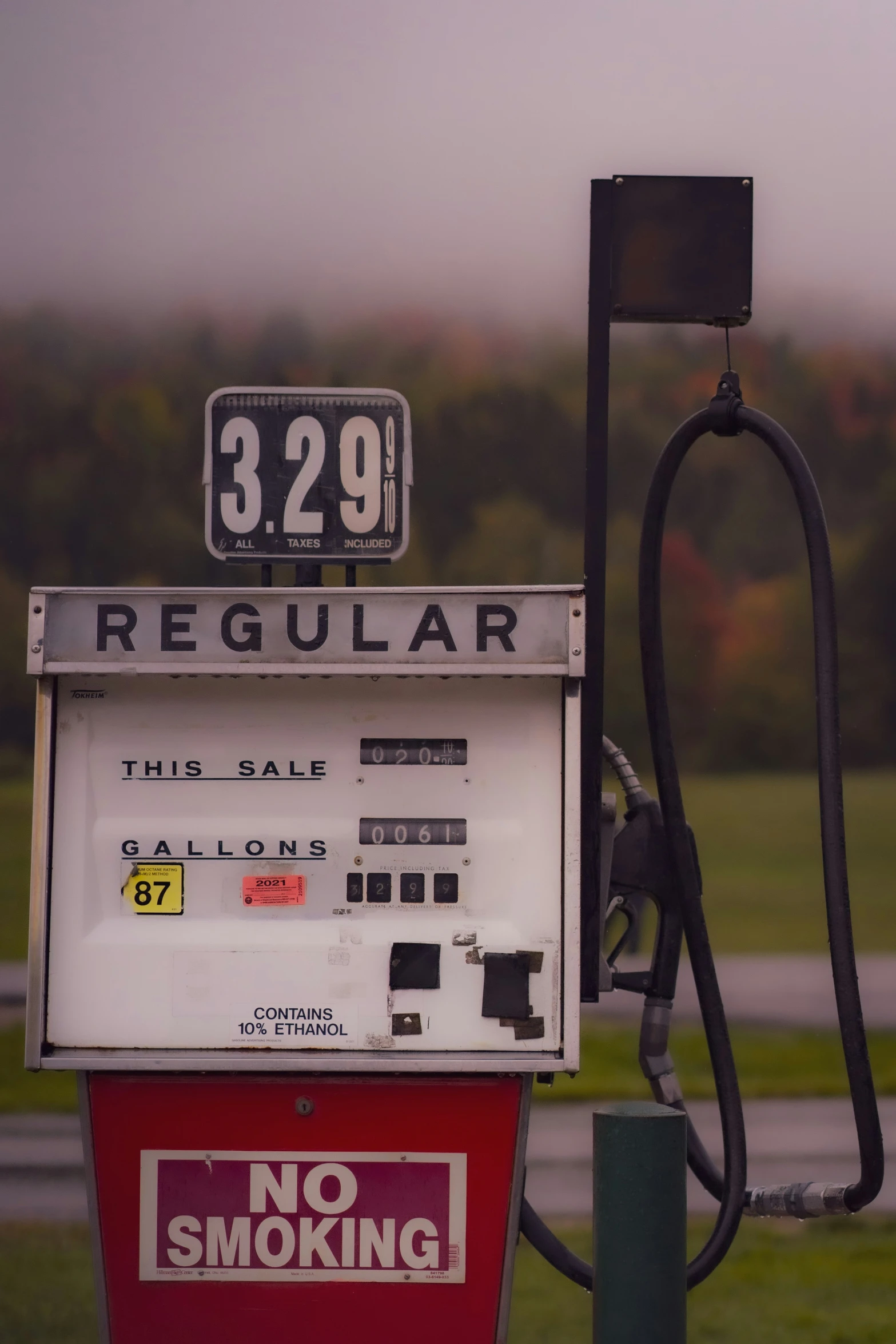 a gas pump, with no smoking sign