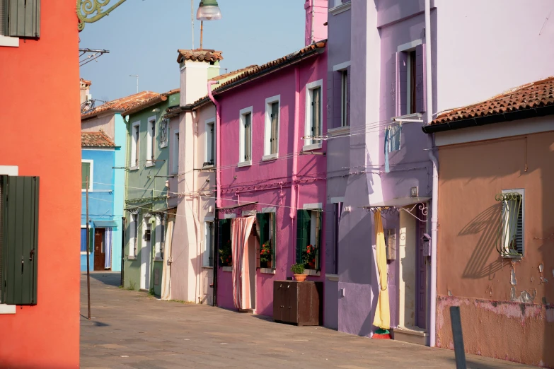 multiple color buildings line the street in an empty town