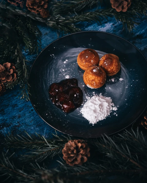 a plate filled with powder, jelly and pine nuts