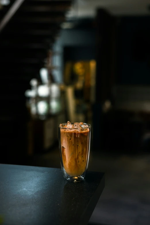 a drink sitting on a table in a dark room