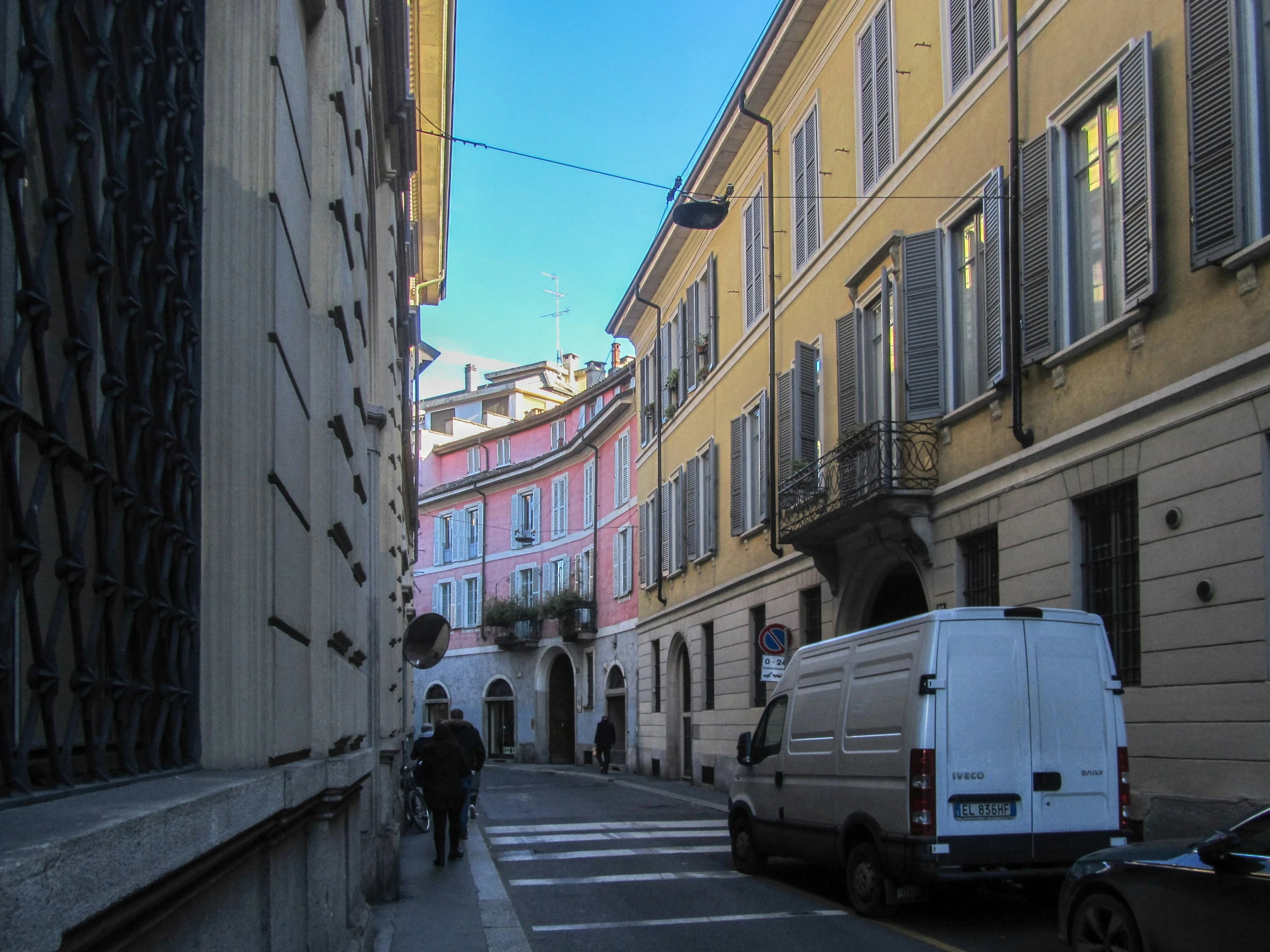 a van on the side of a city street near buildings