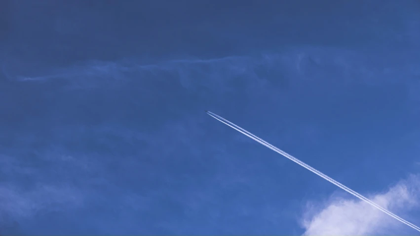 two airplanes are flying on their way through the blue sky