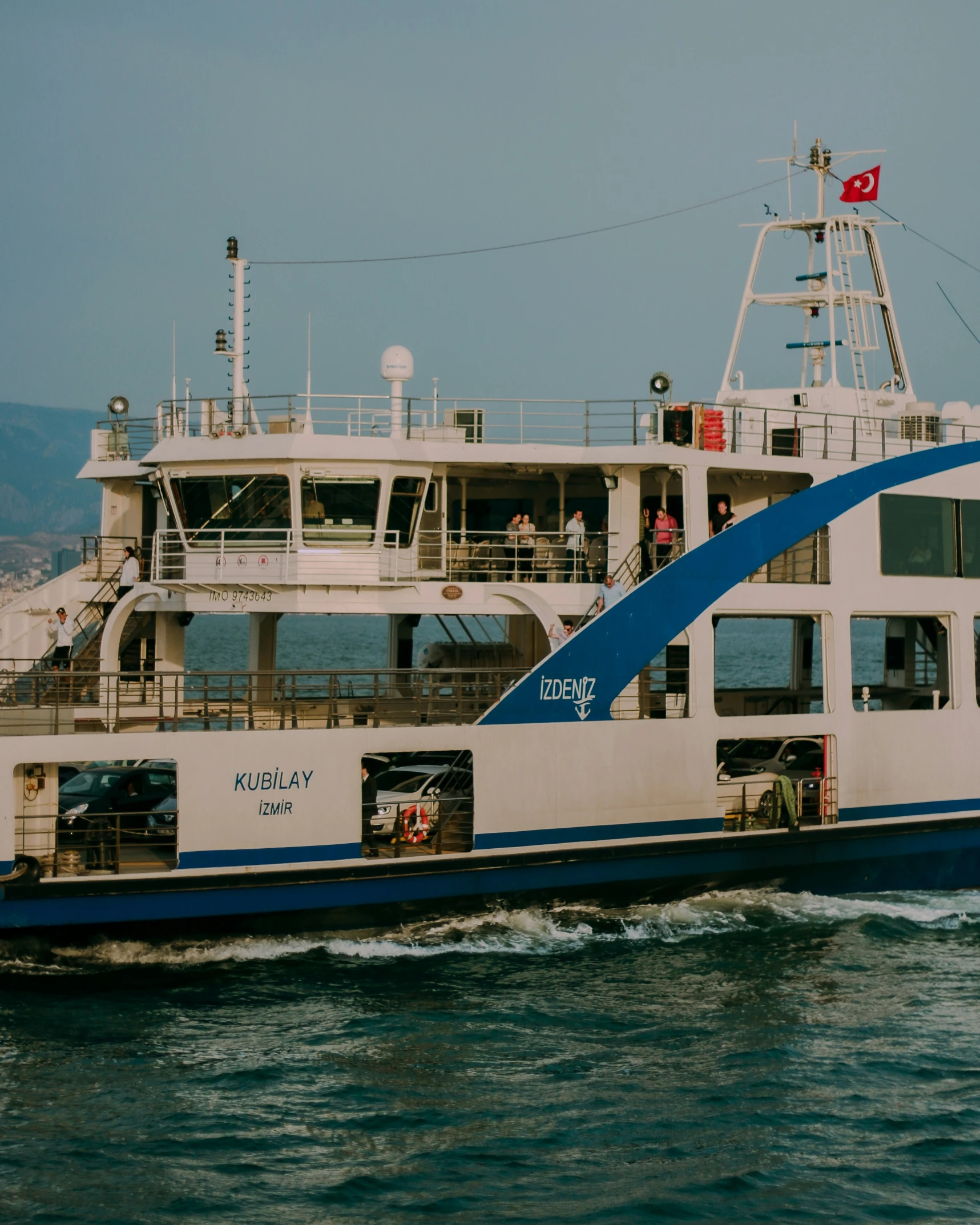 the boat has blue sails and is in the water