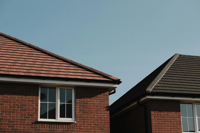 two brick houses with one has windows