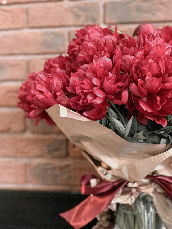 a vase full of flowers is shown next to the wall