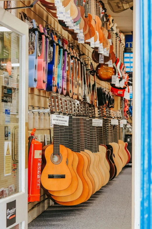 guitars are for sale at a store in the day
