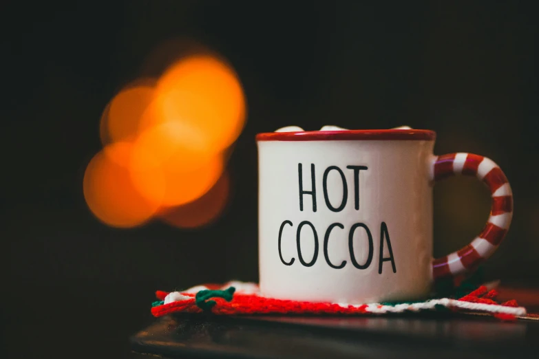 a white coffee mug with a red and green handle