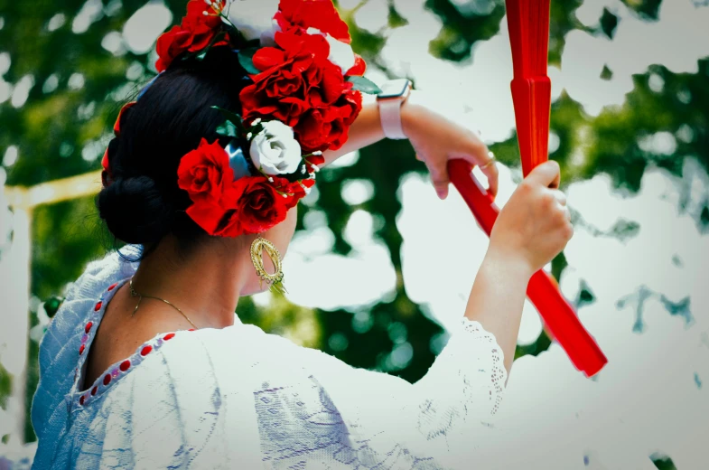 a woman holding a hair comb and red roses