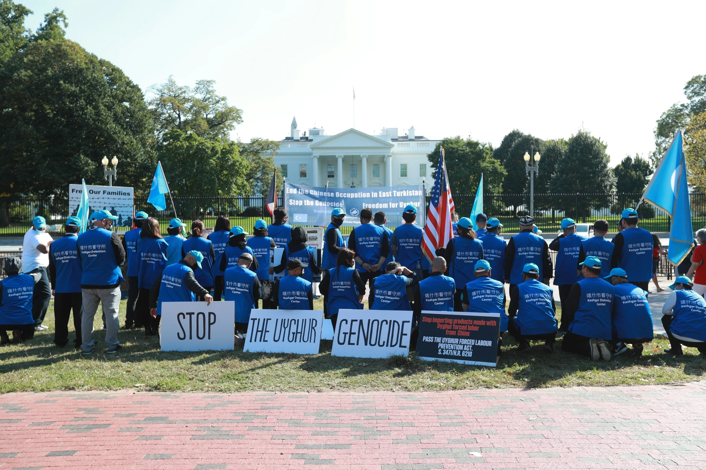 many people in blue shirts standing on the grass