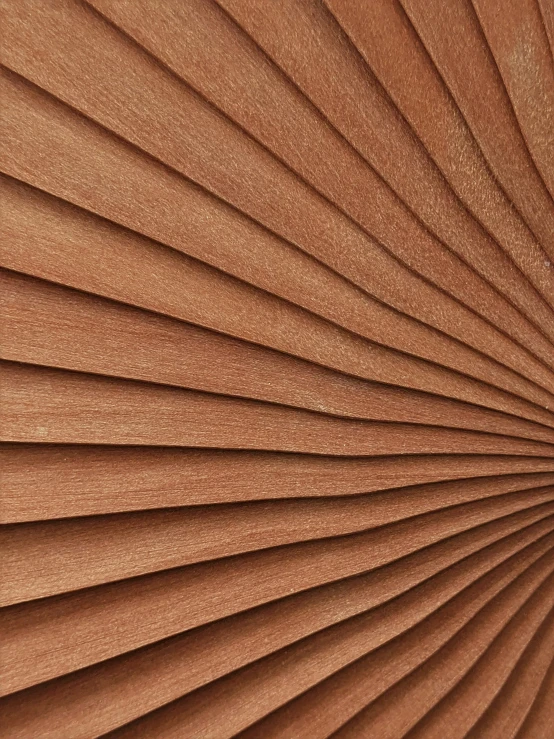 the back of a wooden blinds with brown colored pleating