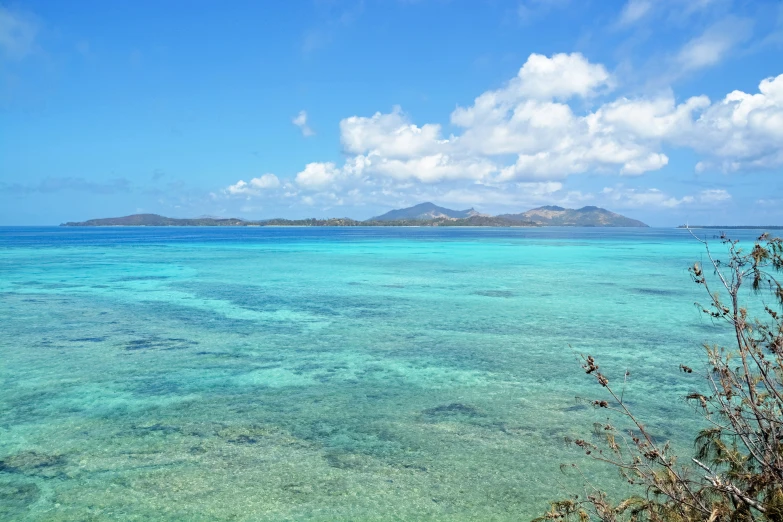 a large body of water sitting next to a small island