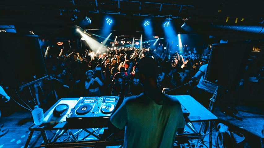 the dj is facing the large crowd in front of him