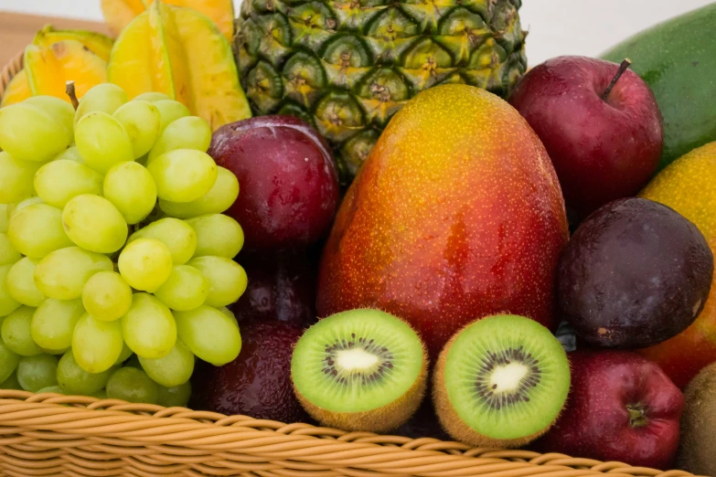 a large basket of assorted fruits sitting next to each other