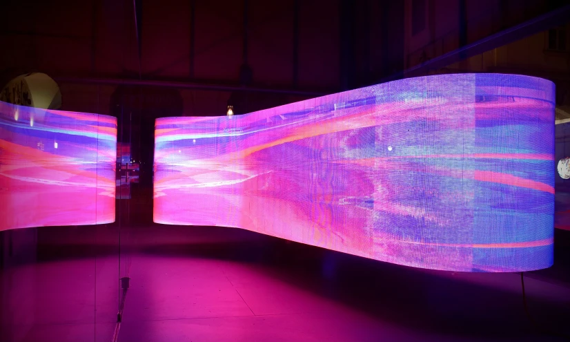 an artistic sculpture featuring three different screens in purple