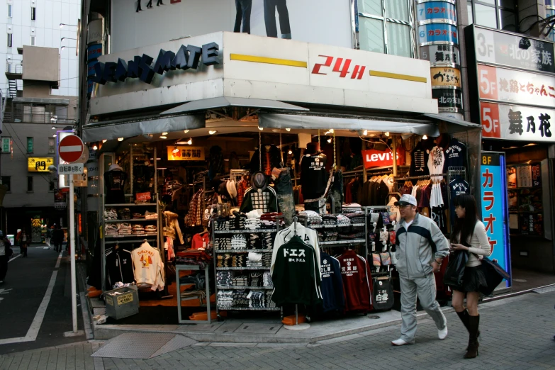 pedestrians walking through the street near a store front