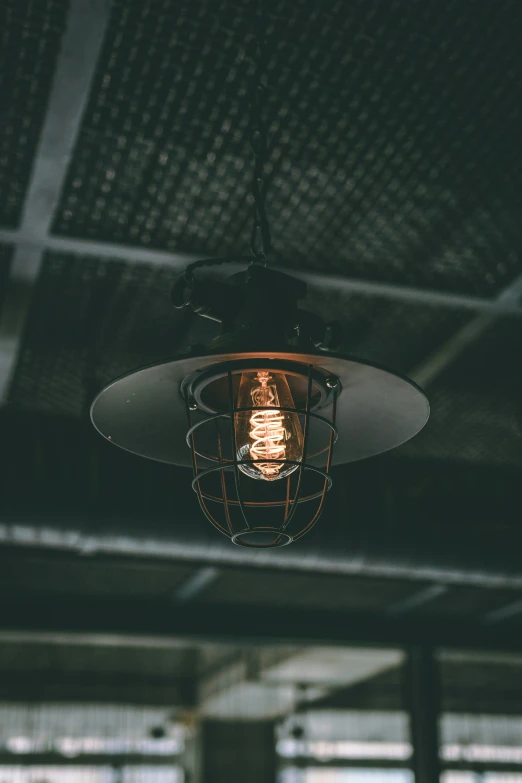 an old metal hanging light fixture hangs from the ceiling