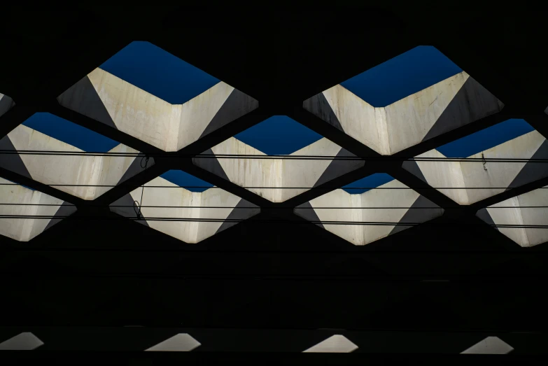 the sky through an unusual structure that appears to be made from cement