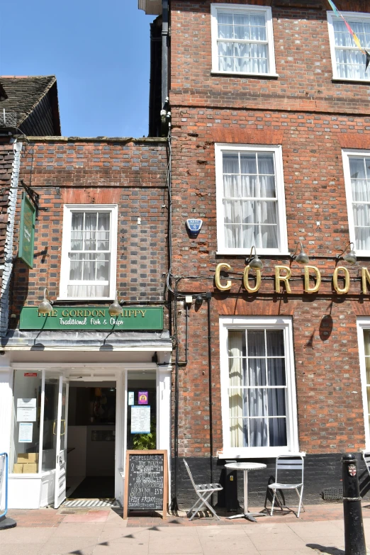 a brick building with a restaurant sign above the front door