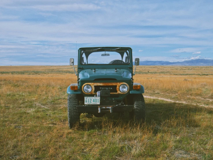 a vehicle parked in a large, open field