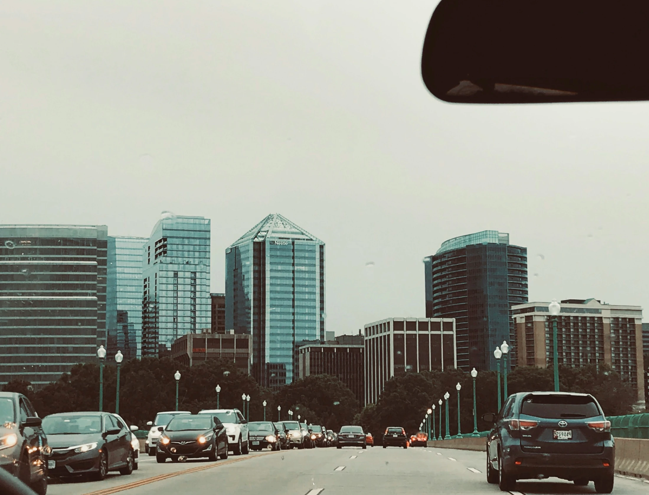 a street full of cars with some skyscrs in the background