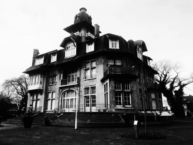 this house has tall steeple and is black and white