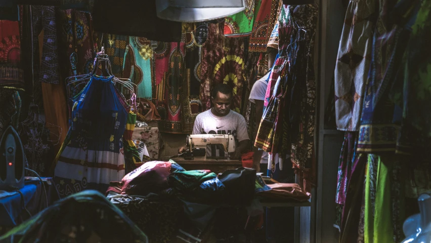 a man in a small room with lots of carpets