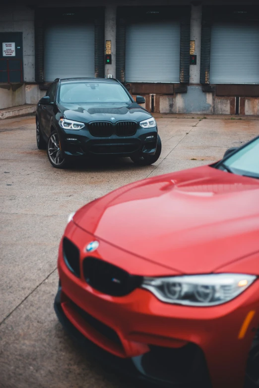 two different bmw models parked next to each other