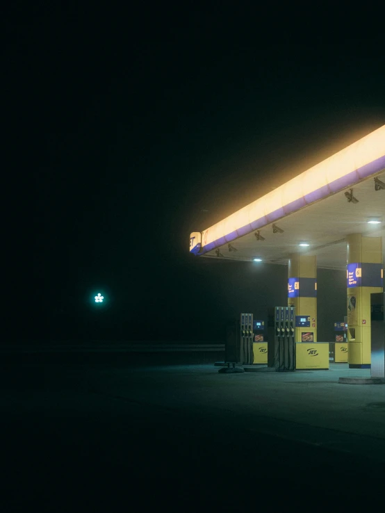 the gas station is lit up at night