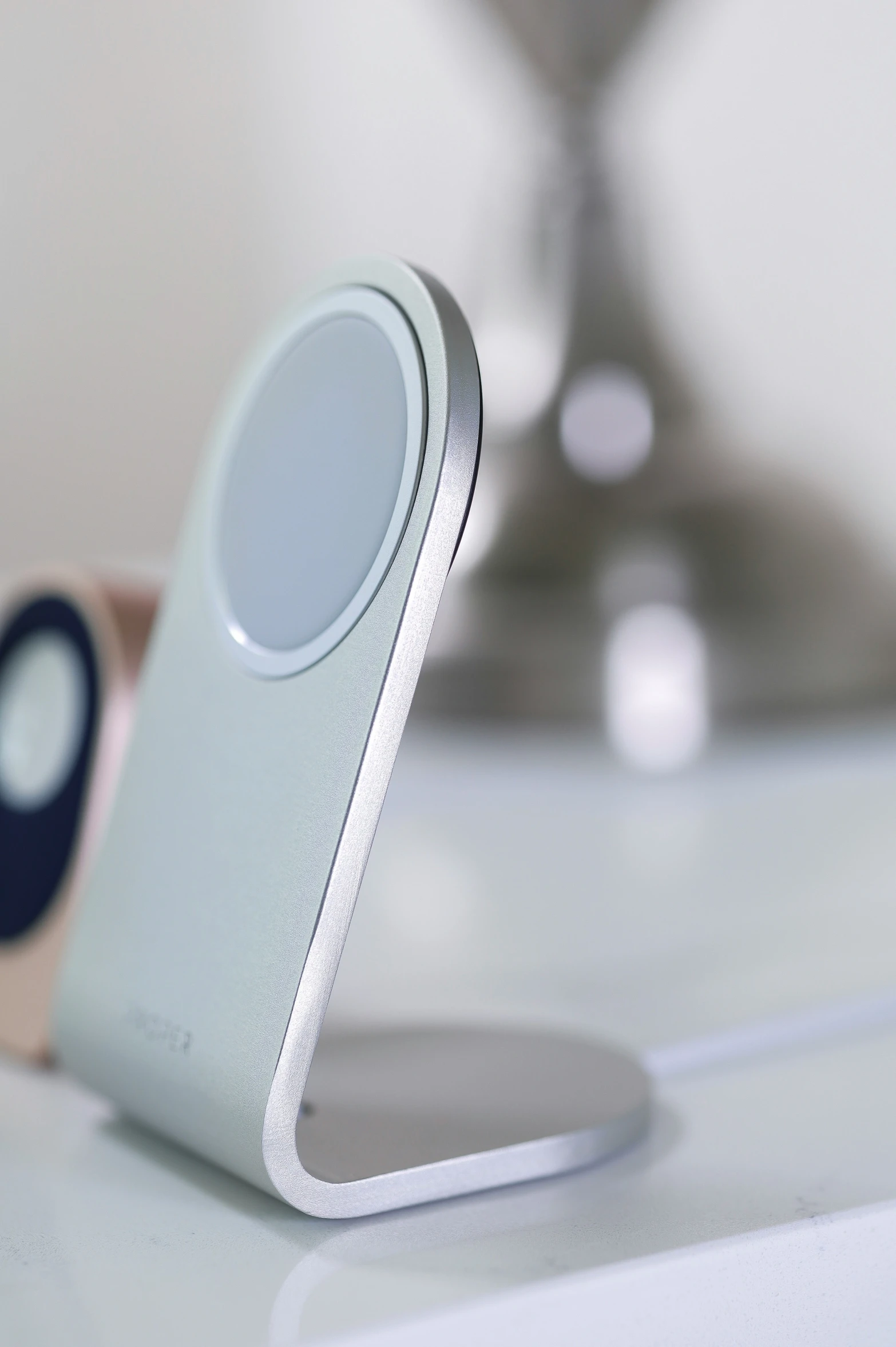 a cell phone charging on the side of a desk