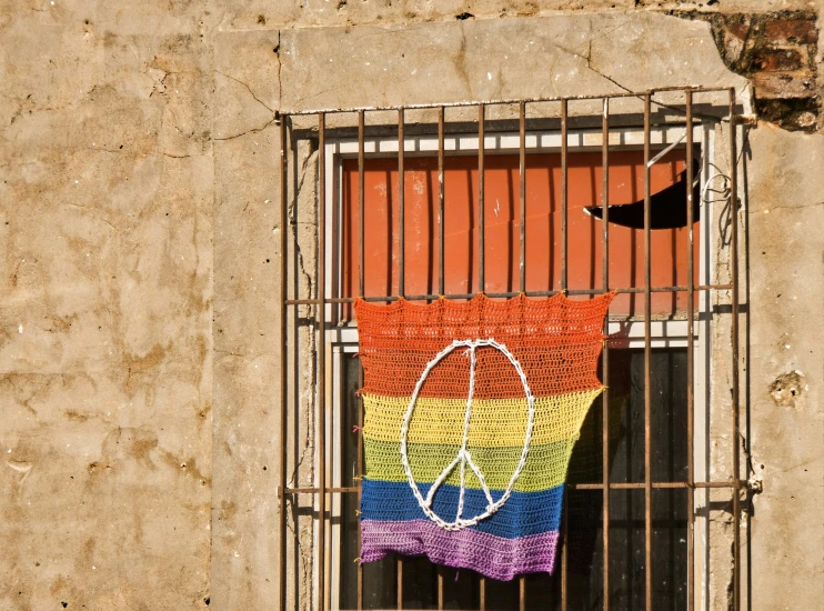 a multicolored peace sign is on the wall