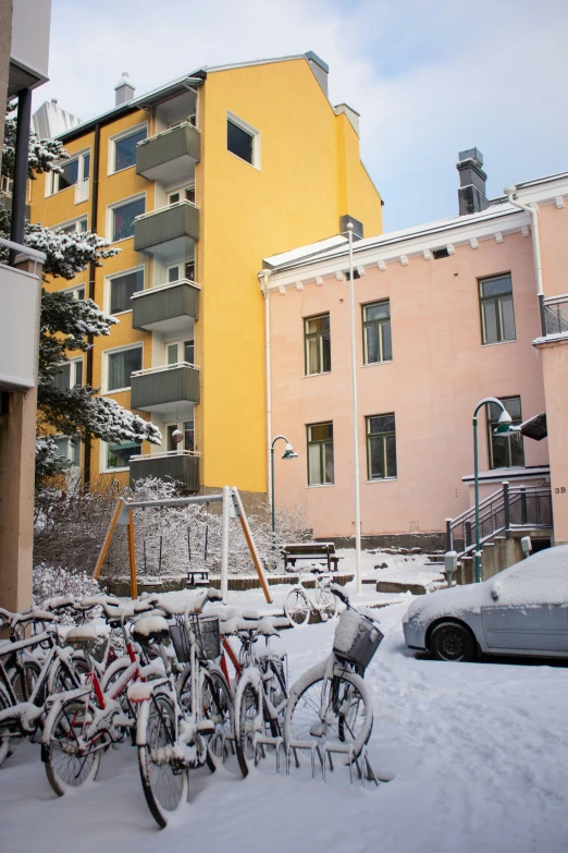 a group of bikes parked outside a large multi story building