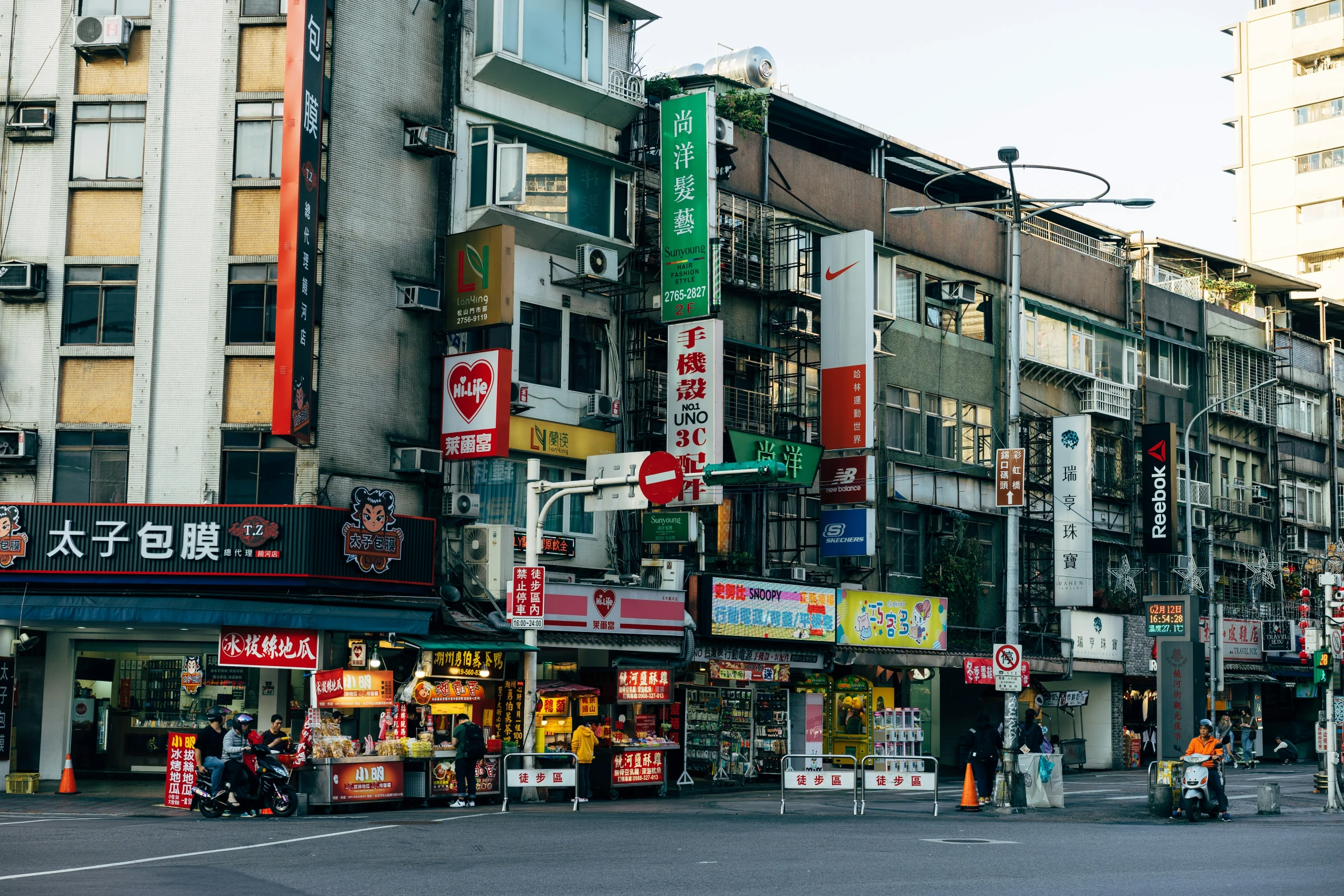 many different stores in a crowded city street