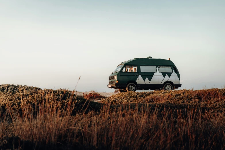 a camper van sits in an outcropping