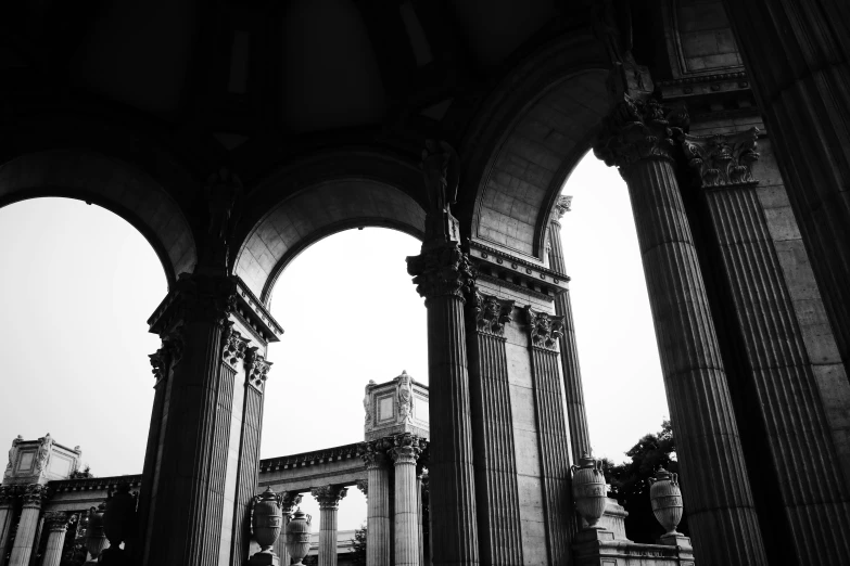 arches and columns are shown against an overcast sky