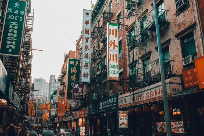 a narrow street that is surrounded by many tall buildings