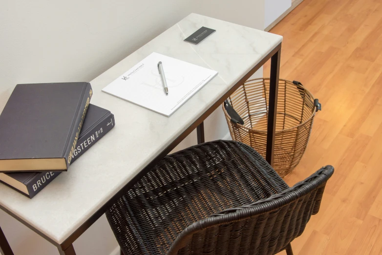 two chairs sit in front of a desk with a notebook