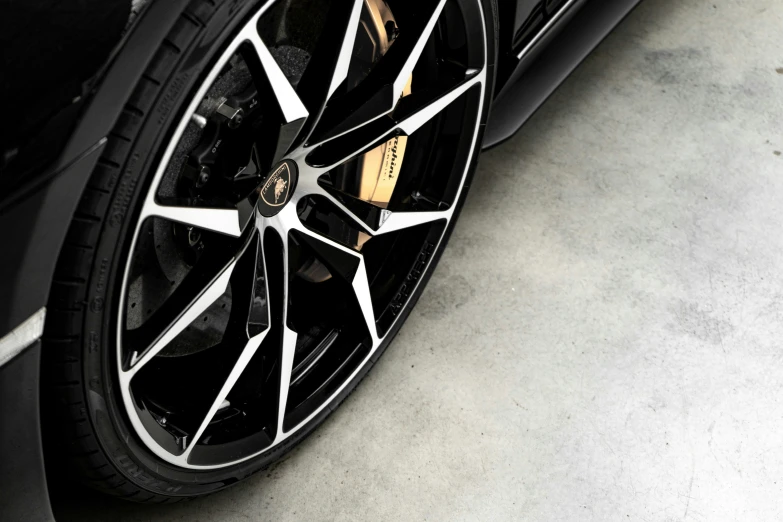a wheel on a car with black wheels