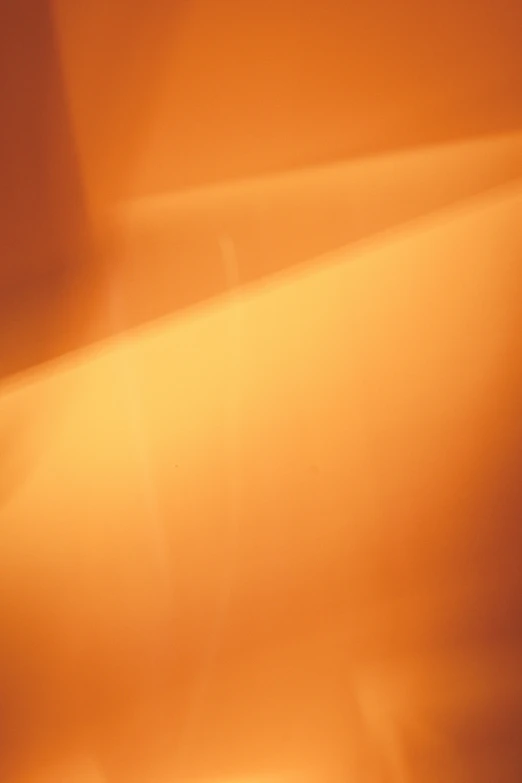 a orange wall with some light shining on it