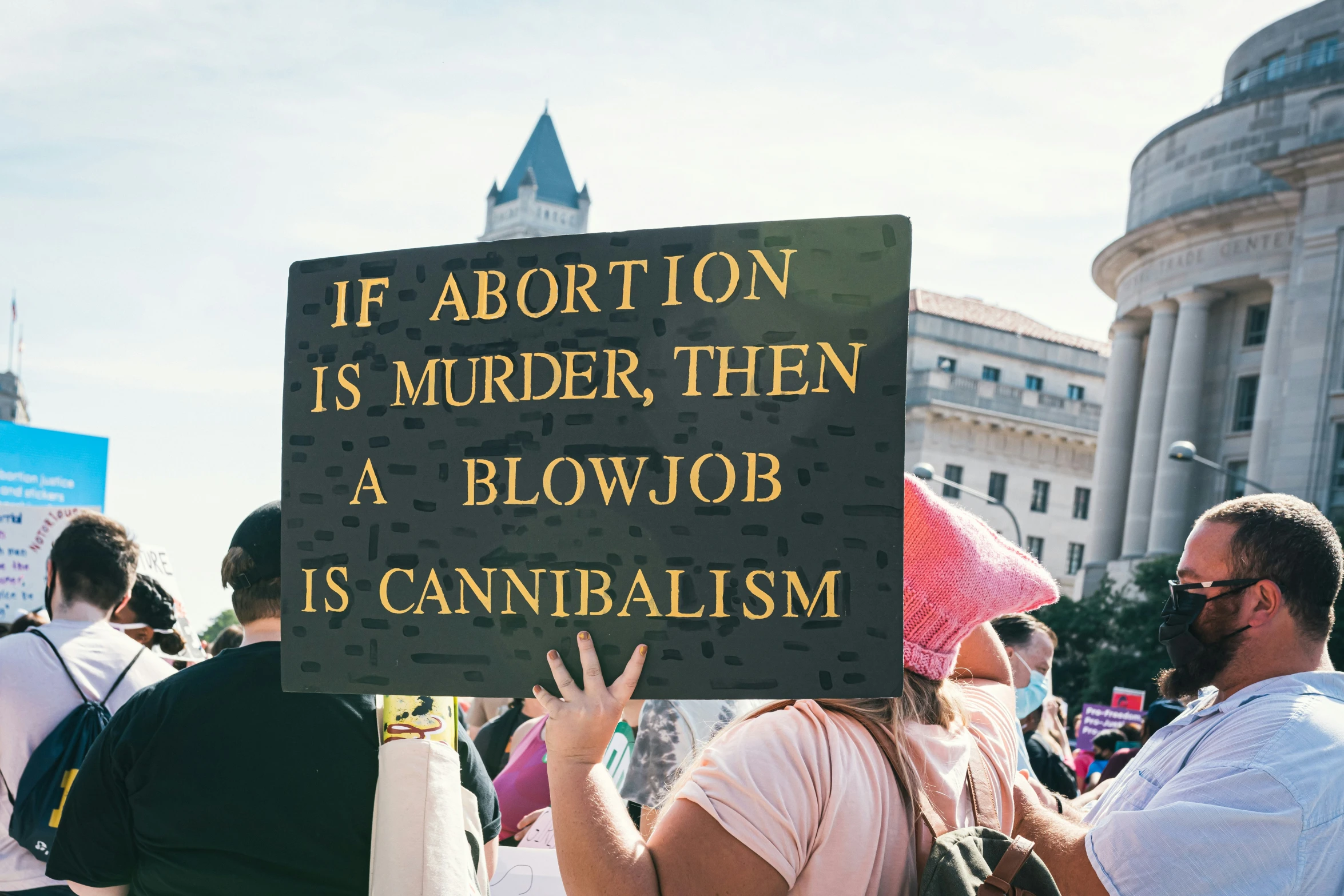 a crowd of people with signs standing in the street