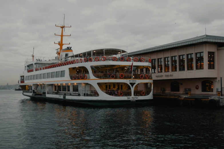 a ferry boat parked next to the side of a building