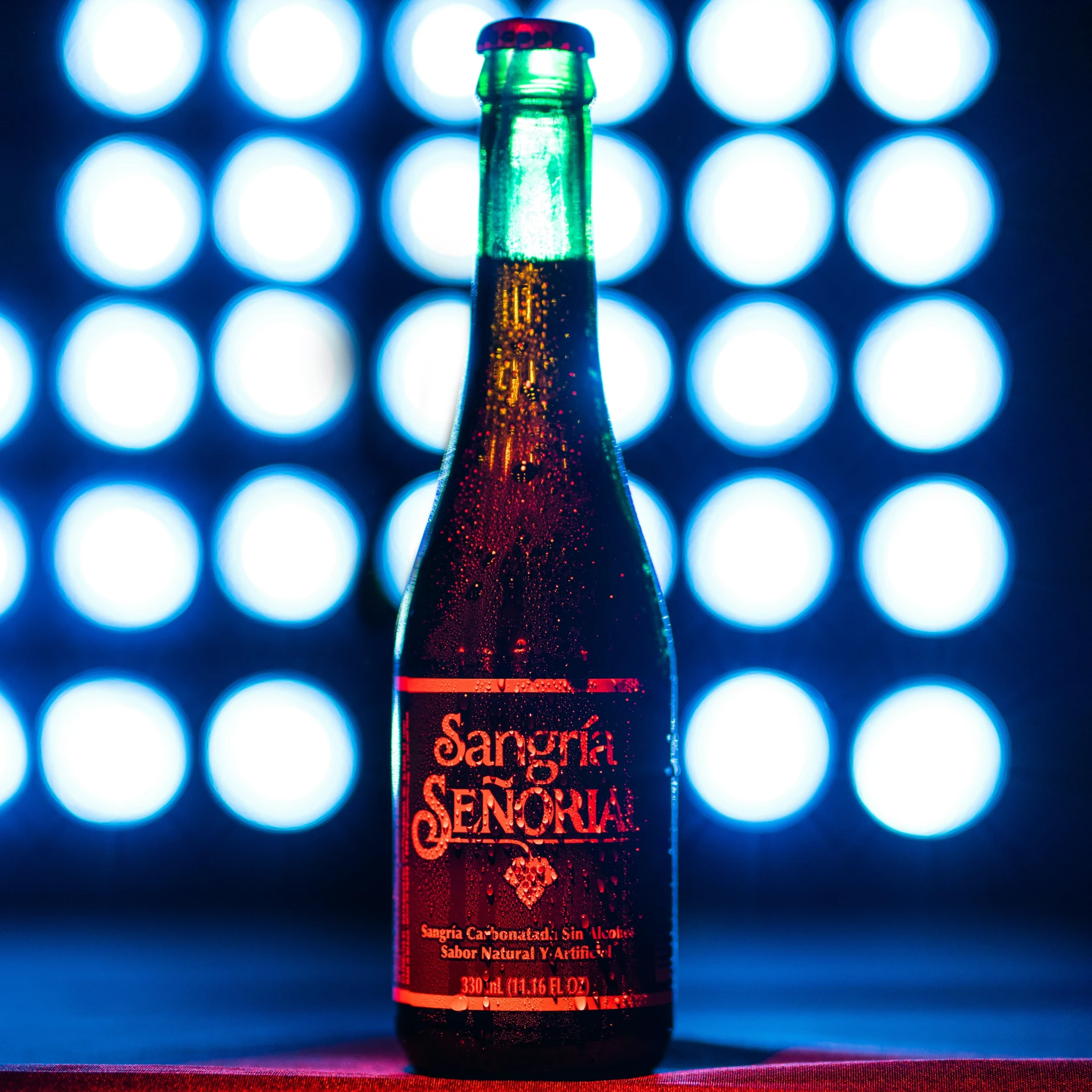 a glass beer bottle sitting on top of a table