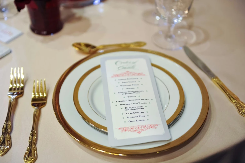 a plate set with gold rims and dinner service