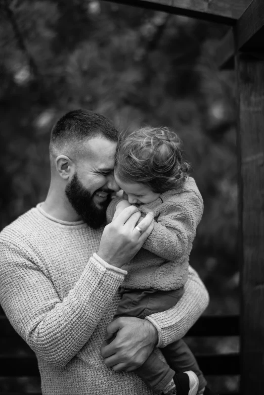 black and white pograph of a man holding a little girl