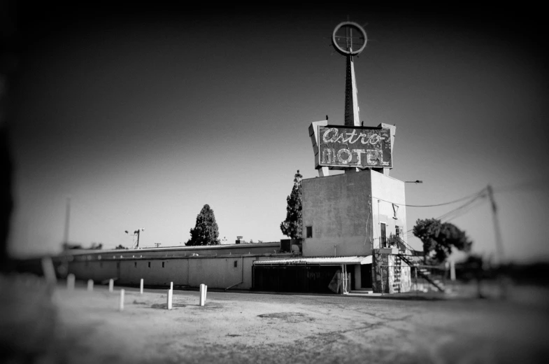 an old motel sign is in the back ground