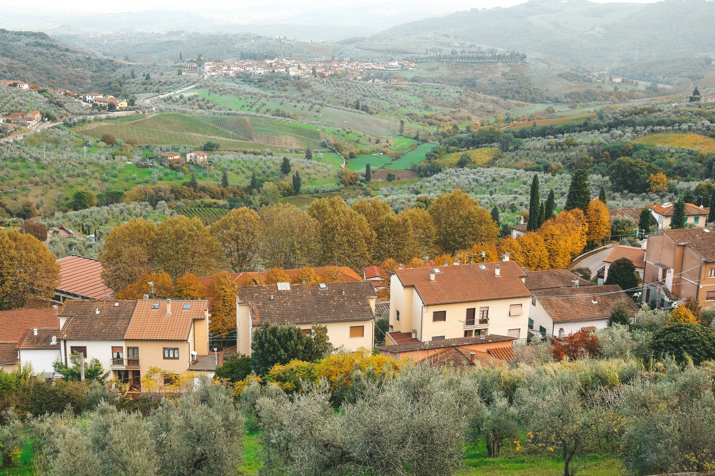 small town nestled on top of a hilly countryside